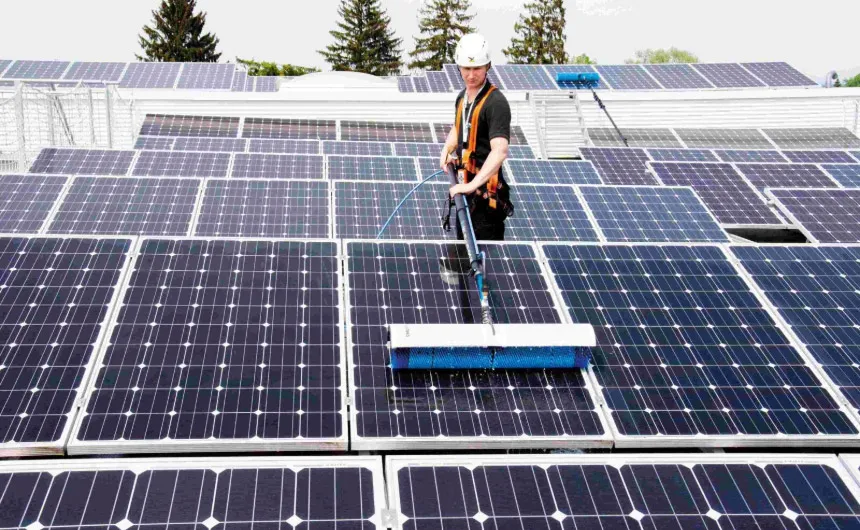 hyCLEANER employee cleans PV system with hand brush system