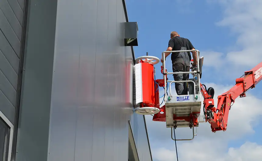 El robot de limpieza facadeBRUSH h-line limpia la fachada de un edificio